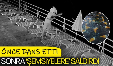 Yüzünü havluyla kapatan bir kişi önce dans etti daha sonra plaj şemsiyelerini denize attı